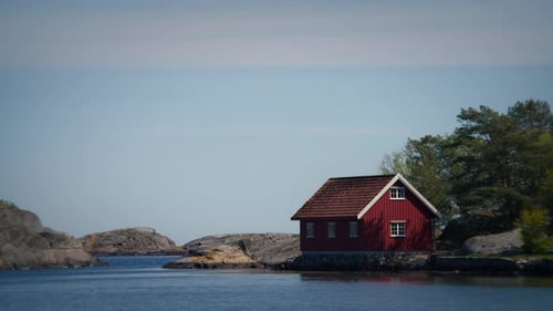Close Up of Red Cabin by Water in Raet National Park Norway