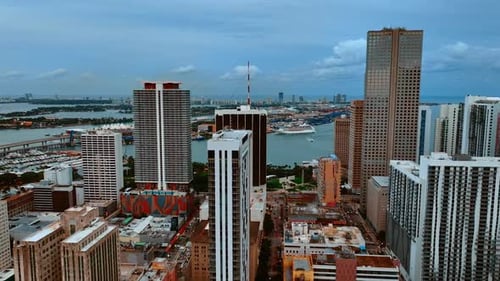 Drone footage among the high-rise buildings and approaching the waterscape. View on Miami, Florida