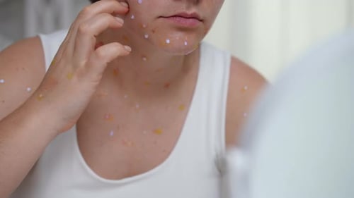Woman Examining Spots on Her Face Close Up