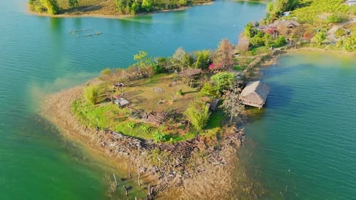 Aerial View of Small Island with Thatched Hut and Swing in Calm Shallow Lake Waters