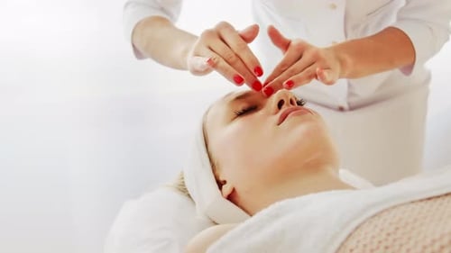 Woman Receiving Facial Massage in Bright Salon