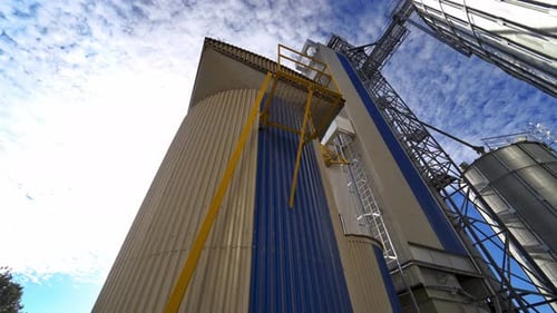 Grain Silos Towering Against a Blue Sky