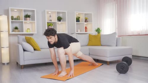 Man Exercising On Yoga Mat Indoors