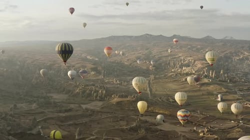 Aerial video of hot air balloons at sunrise, iconic destination behind Cappadocia Turkey