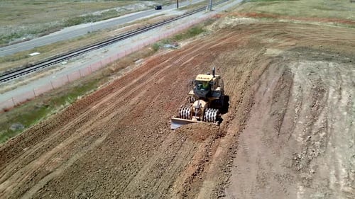 Caterpillar heavy machinery equipment moving dirt, bulldozer and dump truck