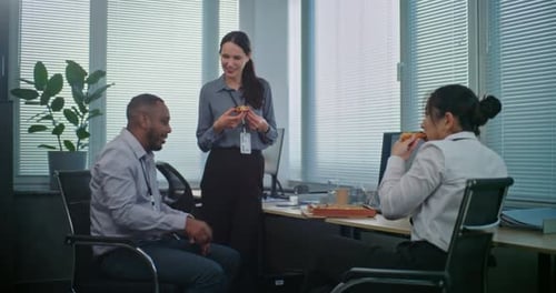 Office Workers Eating Pizza Together at Lunch