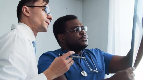 Doctor and Surgeon Talking Near Window Medical Workers in Hospital Office Day Light Healthcare