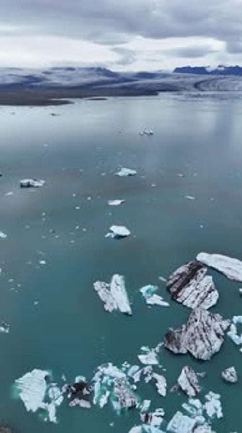 Aerial view of the blue waters and stunning icebergs in the Jökulsárlón lagoon, Iceland.