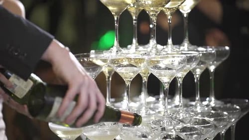 Champagne Tower Being Poured at Wedding Reception