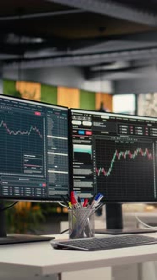 Vertical Video Stock Exchange Insights Displayed on Computer Screens in Hedge Fund Office