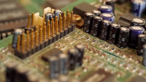 Transistor and capacitors on a computer motherboard close-up