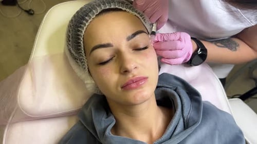 Woman Receiving Facial Filler Injection in Medical Setting