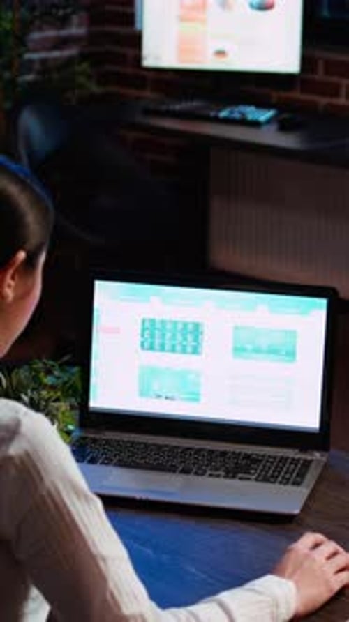 Vertical Video Worker Looking Over Statistical Data Financial Graphs on Laptop Screen