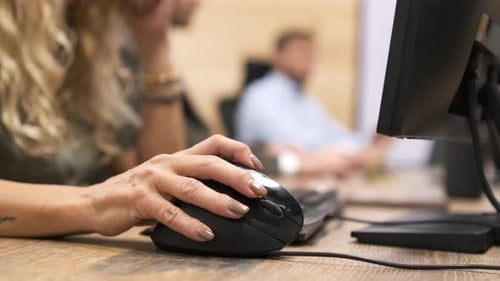 Crop Mature Businesswoman Using Computer Mouse on Desk in Office