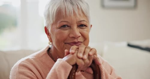 Senior Woman Smiling Warmly With Walking Cane Indoors