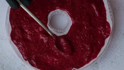 Spreading Raspberry Puree for Homemade Fruit Leather