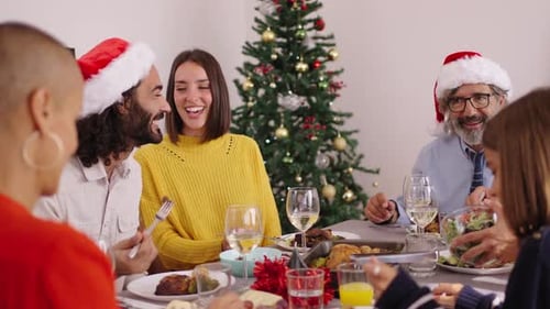 Family Christmas Dinner with Santa Hats and Cheer