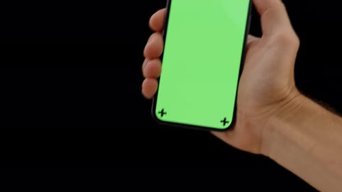 Hand Holding Phone with Green Screen Display