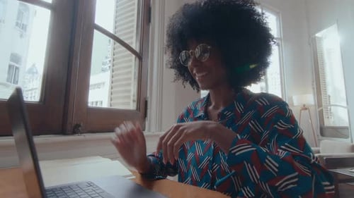 Young Black Businesswoman Web Conferencing on Laptop in the Office