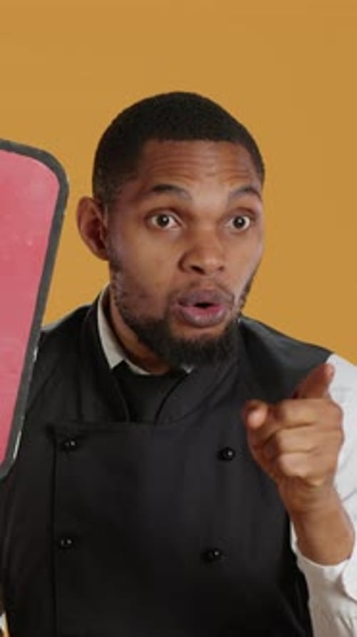 Vertical Video Catering Employee Showing a Message to Vote on Red Speech Bubble