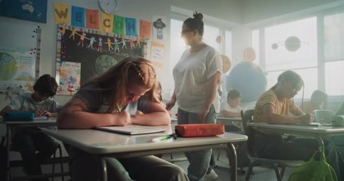Concentrated Primary School Children Writing School Test in Modern Classroom