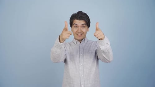 Smiling Man Makes Finger Gun Gesture