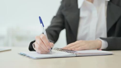Close up of Businesswoman Writing in Office