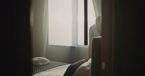 Hotel Room Attendant In Uniform Prepares Accommodation For Next Guest
