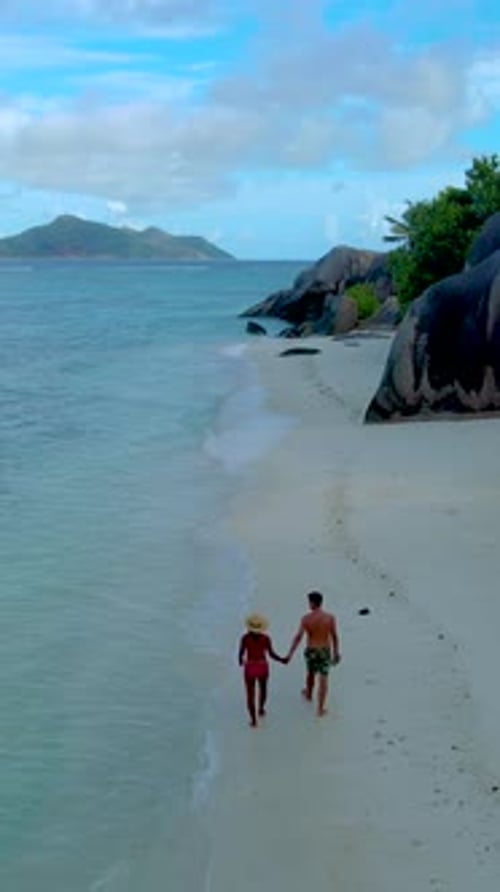 Couple on the Beach of Anse Source D'Argent the Most Beautiful Beach of Seychelles