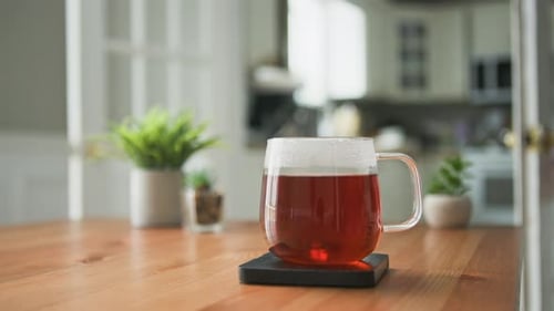 Steaming Tea Cup on Wooden Table Indoors