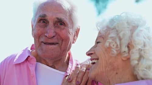 Happy Senior Couple Holding Hands Outdoors