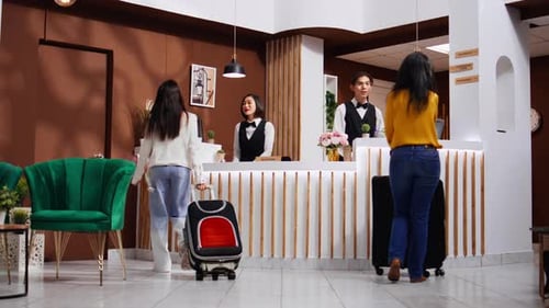 Asian Guests Approach Reception to Ask About Accommodation