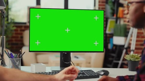 Multiethnic Team Working on Computer with Greenscreen at Home