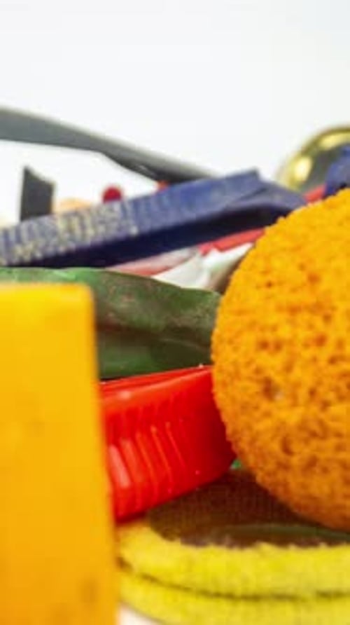 Plastic Rubbish and Waste Items Building Up on White Background in Vertical Format
