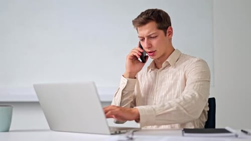 Young Adult Working and Talking on Phone