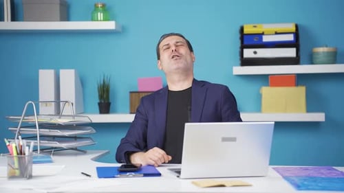 Man Typing on Laptop in Modern Office Environment