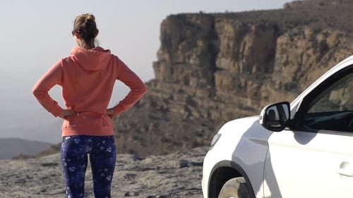 Young woman admiring majestic canyon view in super slow motion on summer road trip