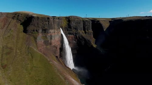 Haifoss Waterfall On A Sunny Summer Day In Southern Iceland. - aerial pullback shot