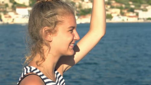 Happy teenage girl sailing boat on sea in Greece super slow motion