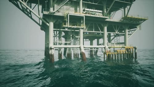 Old Oil Platform Standing Tall in Open Waters During Overcast Weather