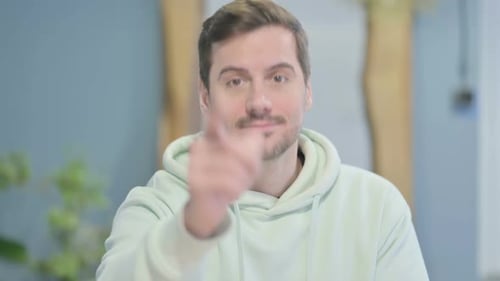 Young Man Points at Viewer