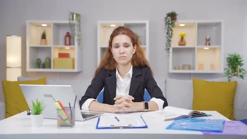 Home office worker woman looking emotional at camera.