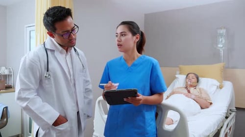 Doctor and Nurse Discuss Patient in Hospital Room
