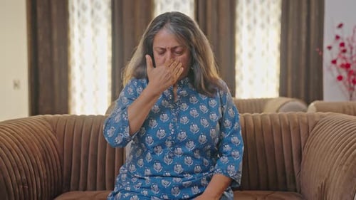 Woman Practices Alternate Nostril Breathing on Couch