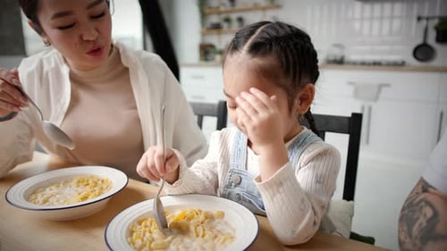 Family Enjoys Cereal Breakfast Together at Home