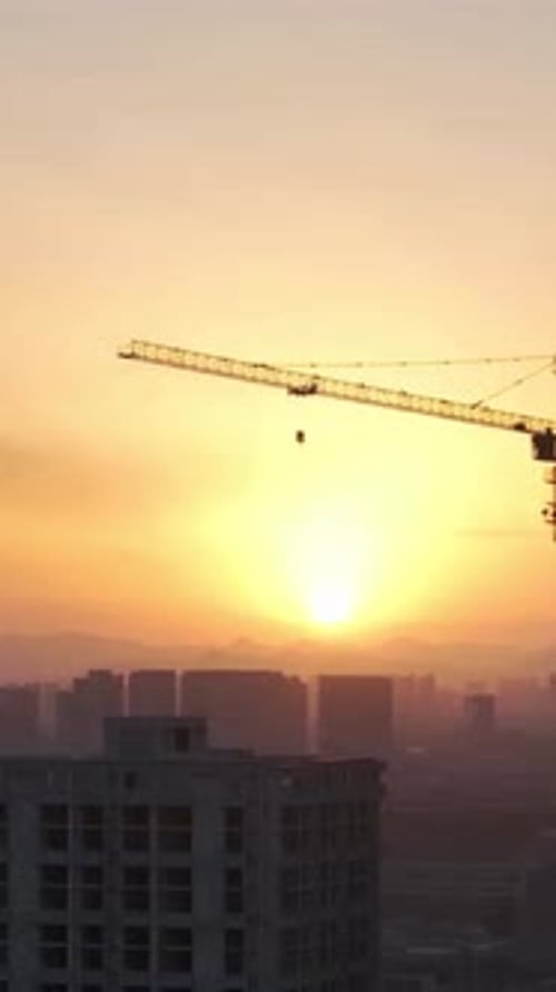 Vertical View Of Buildings Construction With Cranes
