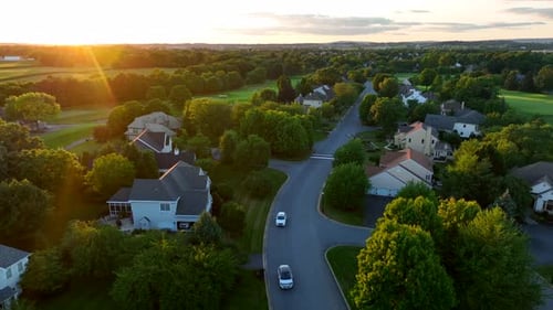 Cars drive in private country club estate. Gated community with golf course and huge expensive