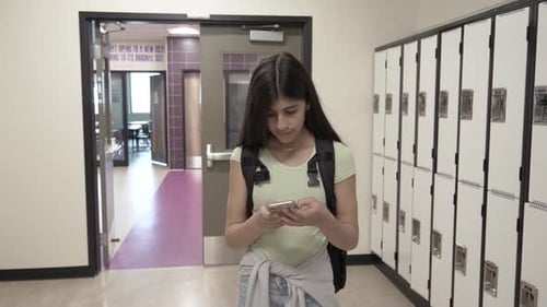 Slow Motion Of Student Using Phone In School Corridor