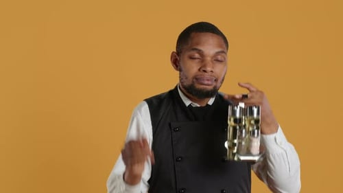 Man Standing with Spice Rack Looking Confused