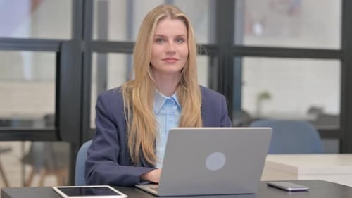 Smiling Young Adult Woman Working at Computer